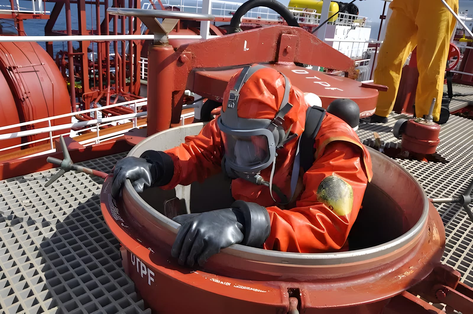 Marine engineer carrying out a survey in a confined space