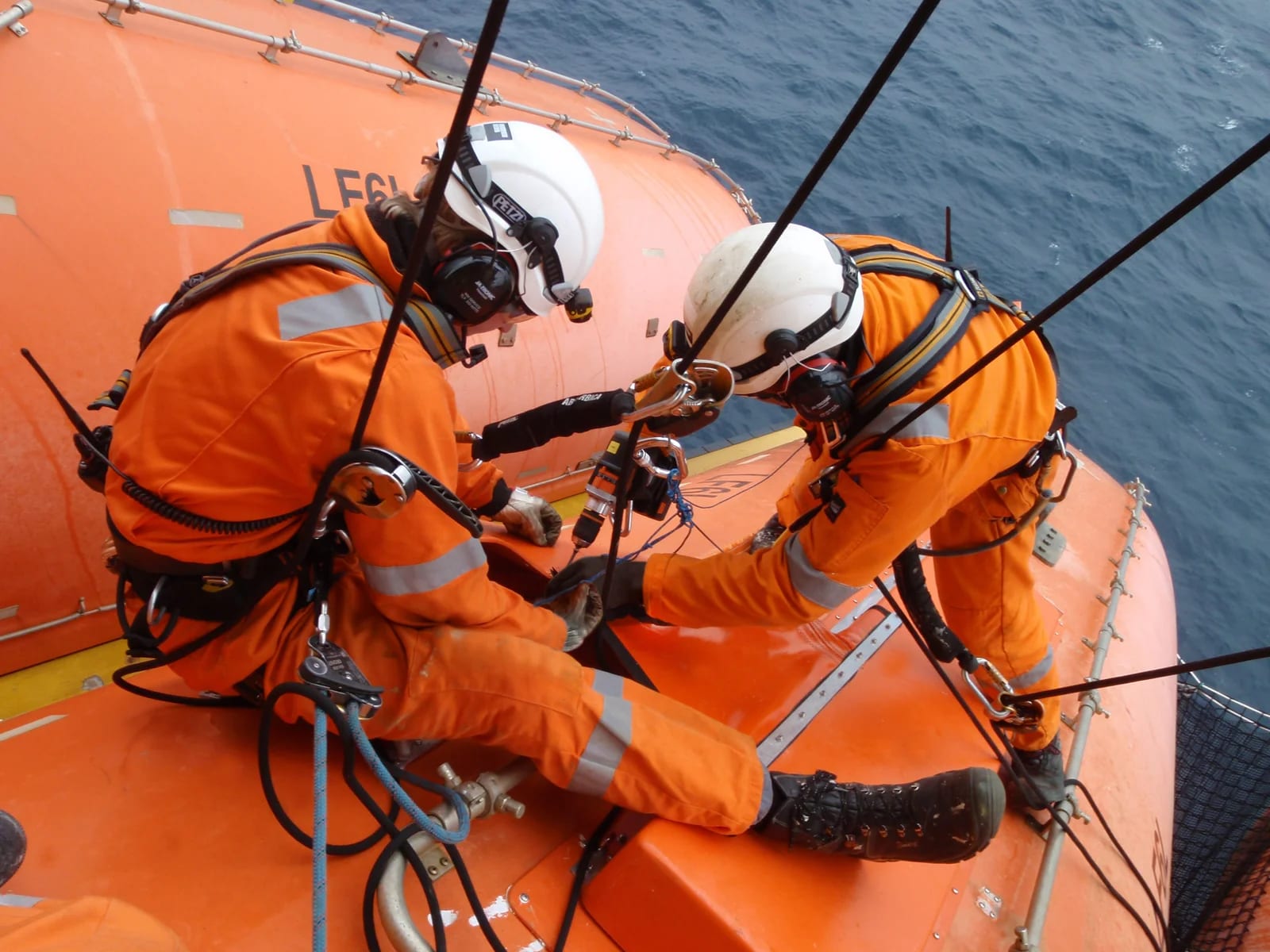 Technicians servicing a lifeboat at the SOLAS MODU service station